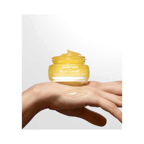Darphin Eclat Sublime Aromatic Vetiver Revitalizing Mask shown in a glass jar with gel texture applied on hand, ideal for face and neck care.