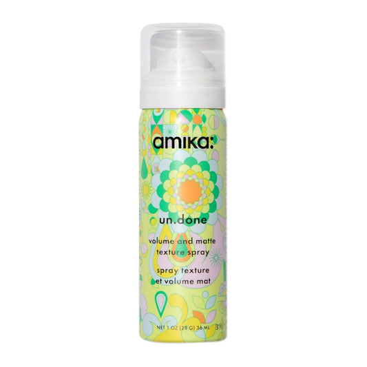 Amika Un.Done Volume Texture Spray 28g reisestørrelse med fargerik blomsterdesign, ideell for matt finish og umiddelbar volum på farten.
