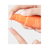 Hand applying Allies of Skin Vitamin C Serum for Face, demonstrating precise pump dispenser and smooth serum texture for facial treatment.