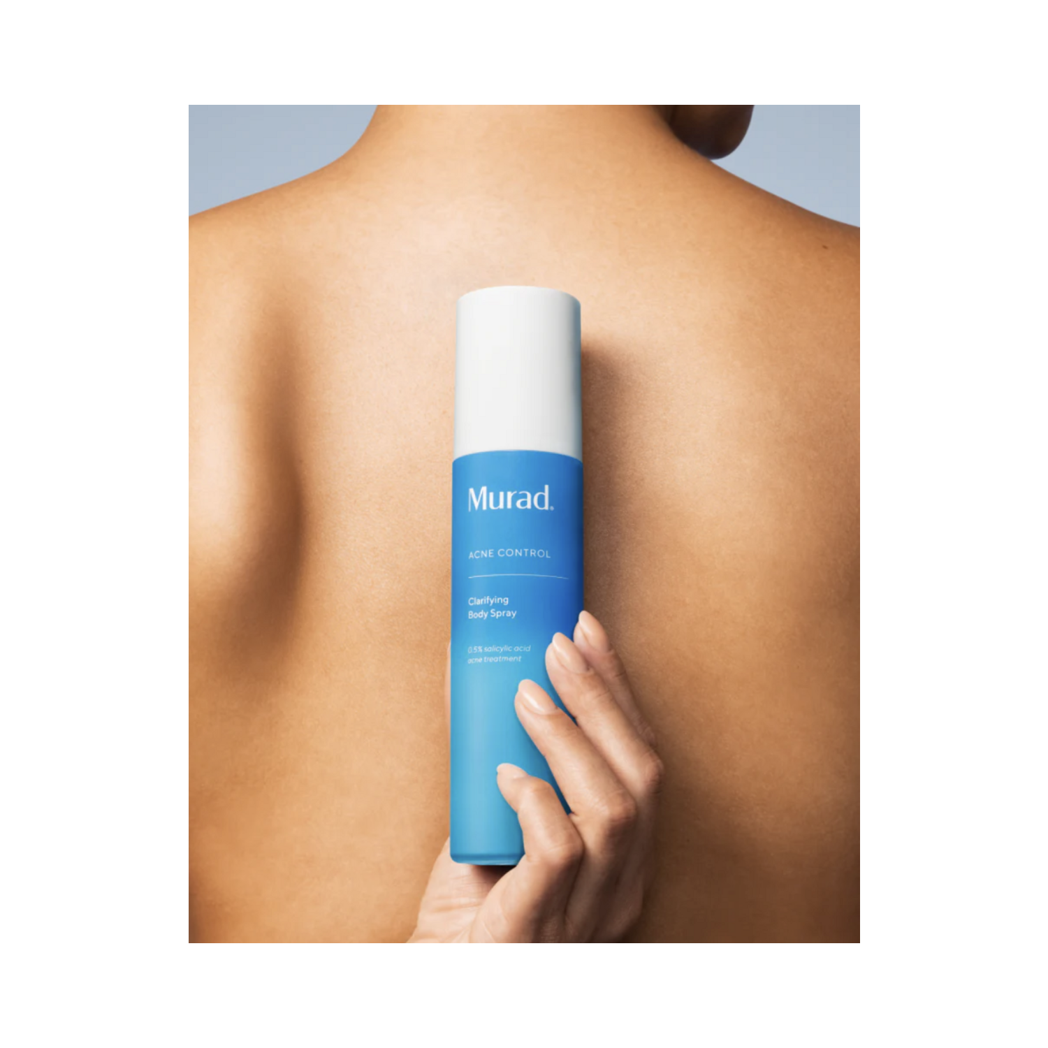 Murad Acne Body Spray held against back, highlighting ease of use and effectiveness in preventing body breakouts.
