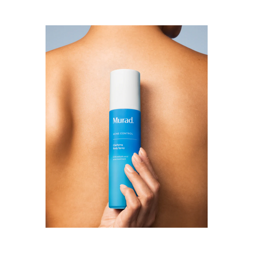 Murad Acne Body Spray held against back, highlighting ease of use and effectiveness in preventing body breakouts.