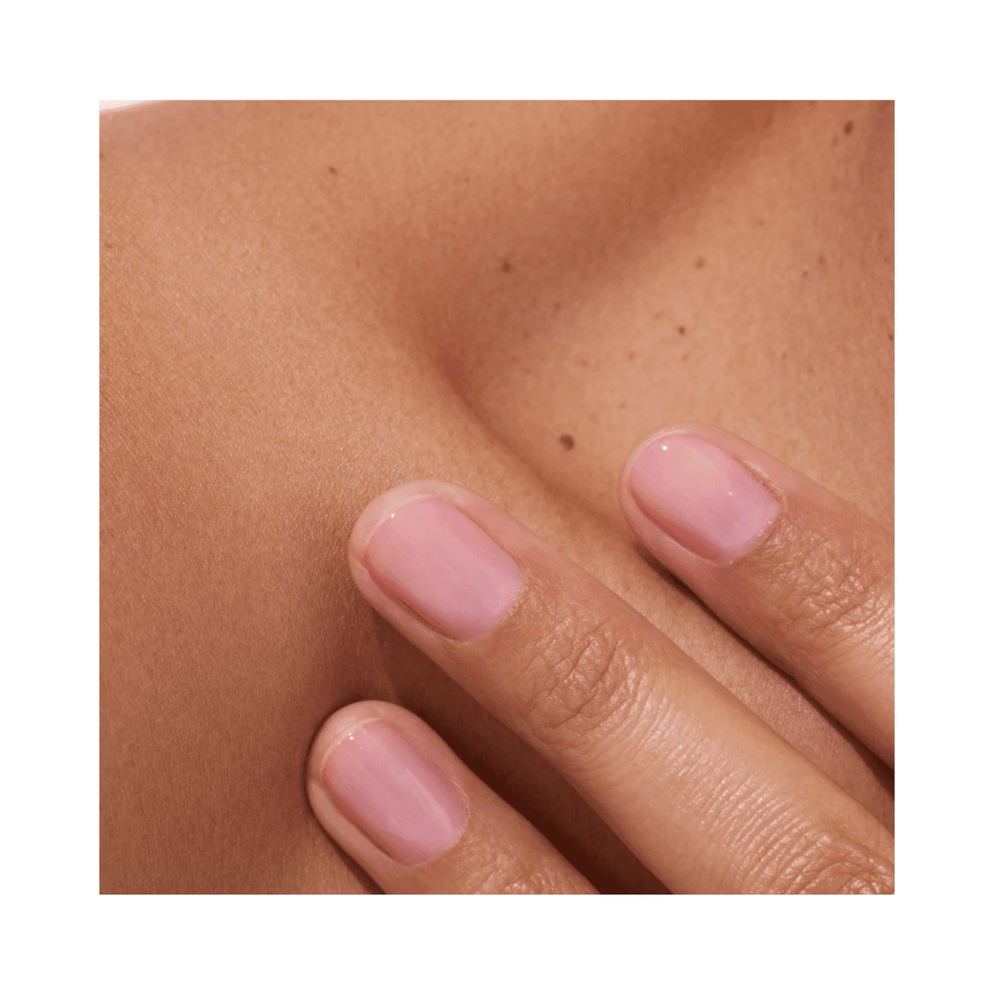 Glossy pink-toned nails with Active Bright polish on a natural skin background. Promotes healthy, radiant nail appearance.