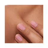 Glossy pink-toned nails with Active Bright polish on a natural skin background. Promotes healthy, radiant nail appearance.
