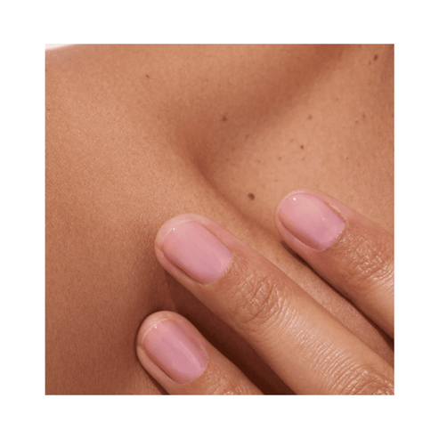 Close-up of nails with Manucurist Active Glow Blueberry polish showing luminous, soft pink glow on natural nails.