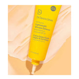 Dr Dennis Gross SPF 30 sunscreen tube on peach background with open tip, highlighting all-physical, wrinkle defense sun care solution.