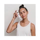 Model holding Circadia Aloe and Calendula Calming Mist, showcasing its use for calming facial redness and sensitive skin. Shop now at eSkinCareStore.