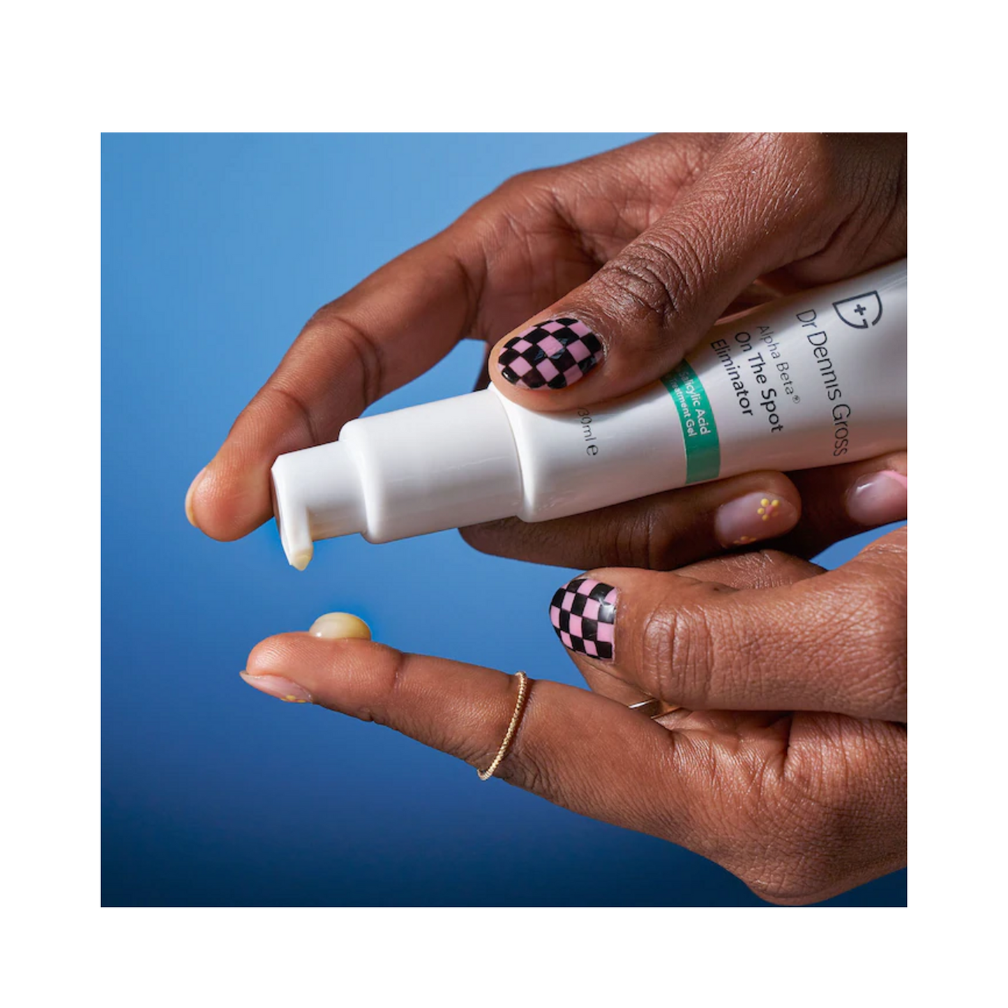 Fingertip application of Dr Dennis Gross Spot Eliminator gel, demonstrating product texture and targeted skincare use for acne-prone areas.