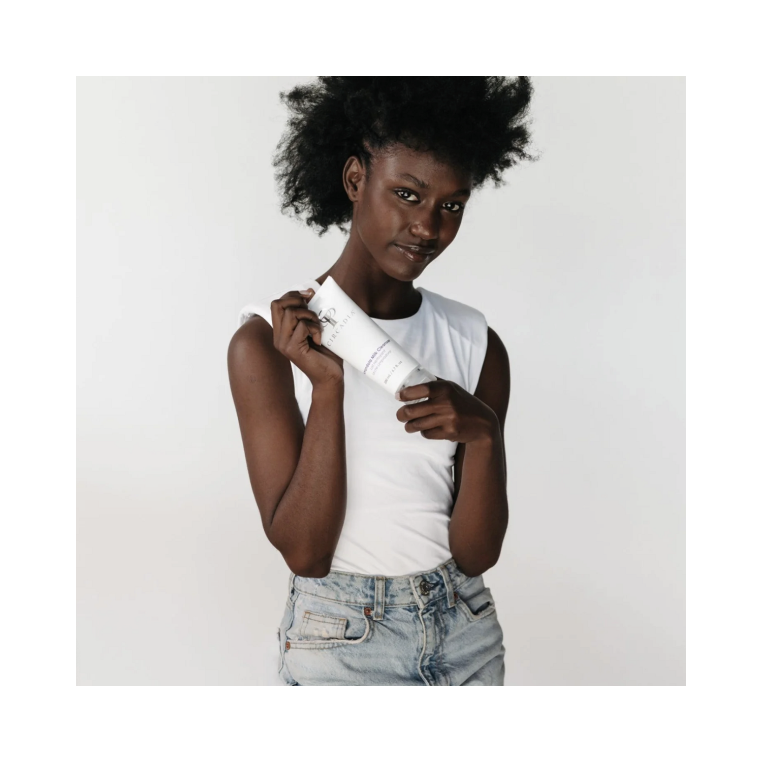 Model holding Circadia Amandola Milk Cleanser - Exfoliate & Hydrate | Gentle Skincare, ideal for dry and sensitive skin with lactic acid and milk protein.