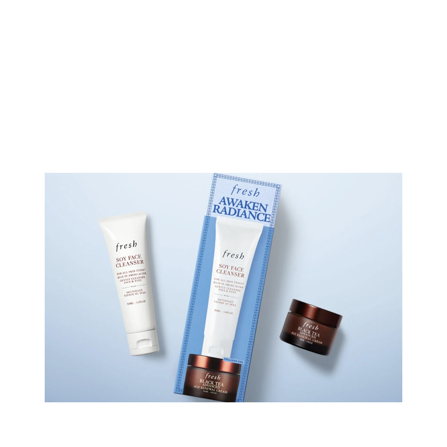 Flat lay of Fresh Awaken Radiance Skin Care Kit with cleanser, cream, and box packaging for anti-aging skincare routine.