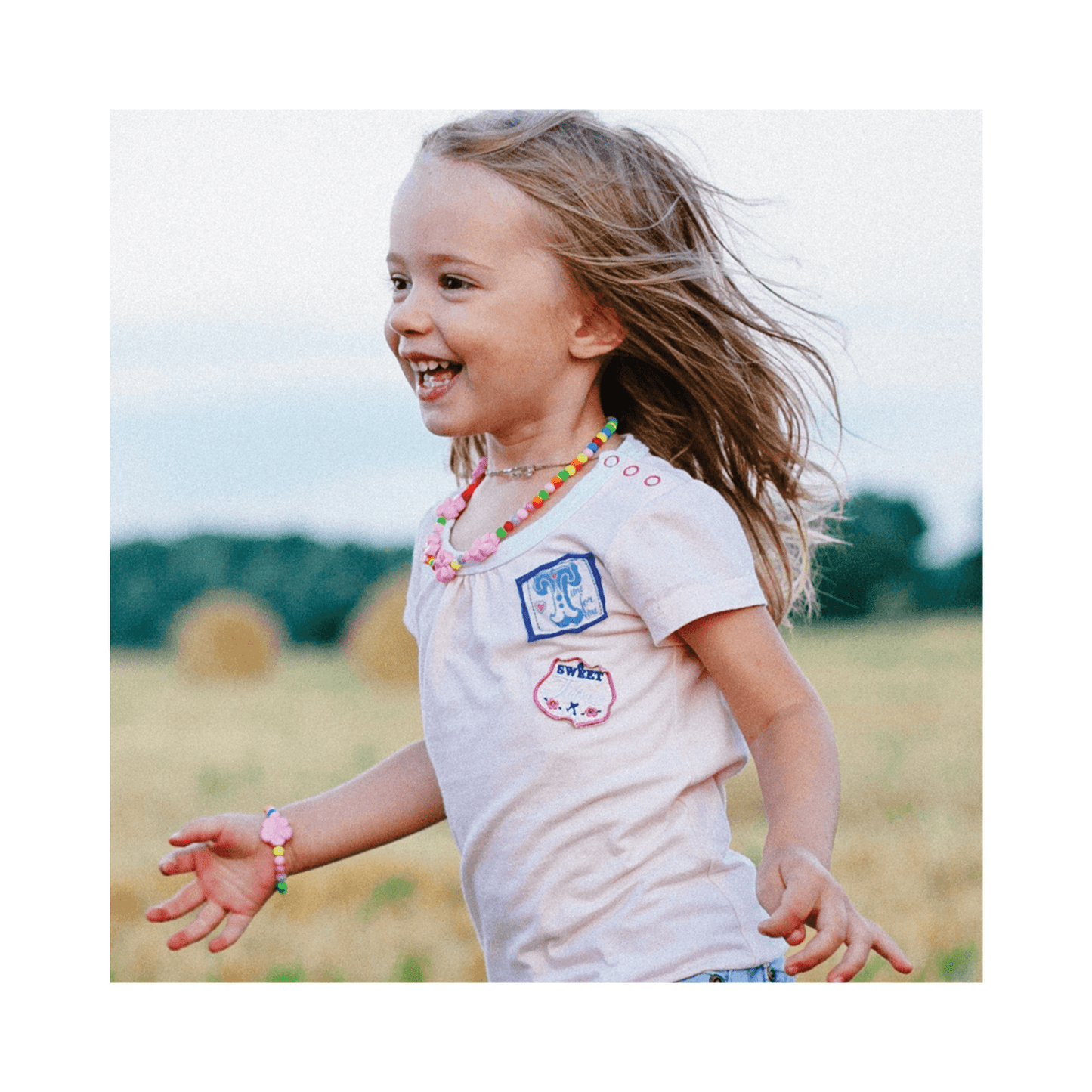 Smiling child outdoors, representing safe use of Nelly Devuyst Mineral Sunscreen SPF 30 for gentle, broad-spectrum sun protection.