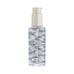 Hair treatment oil in clear bottle with pump dispenser