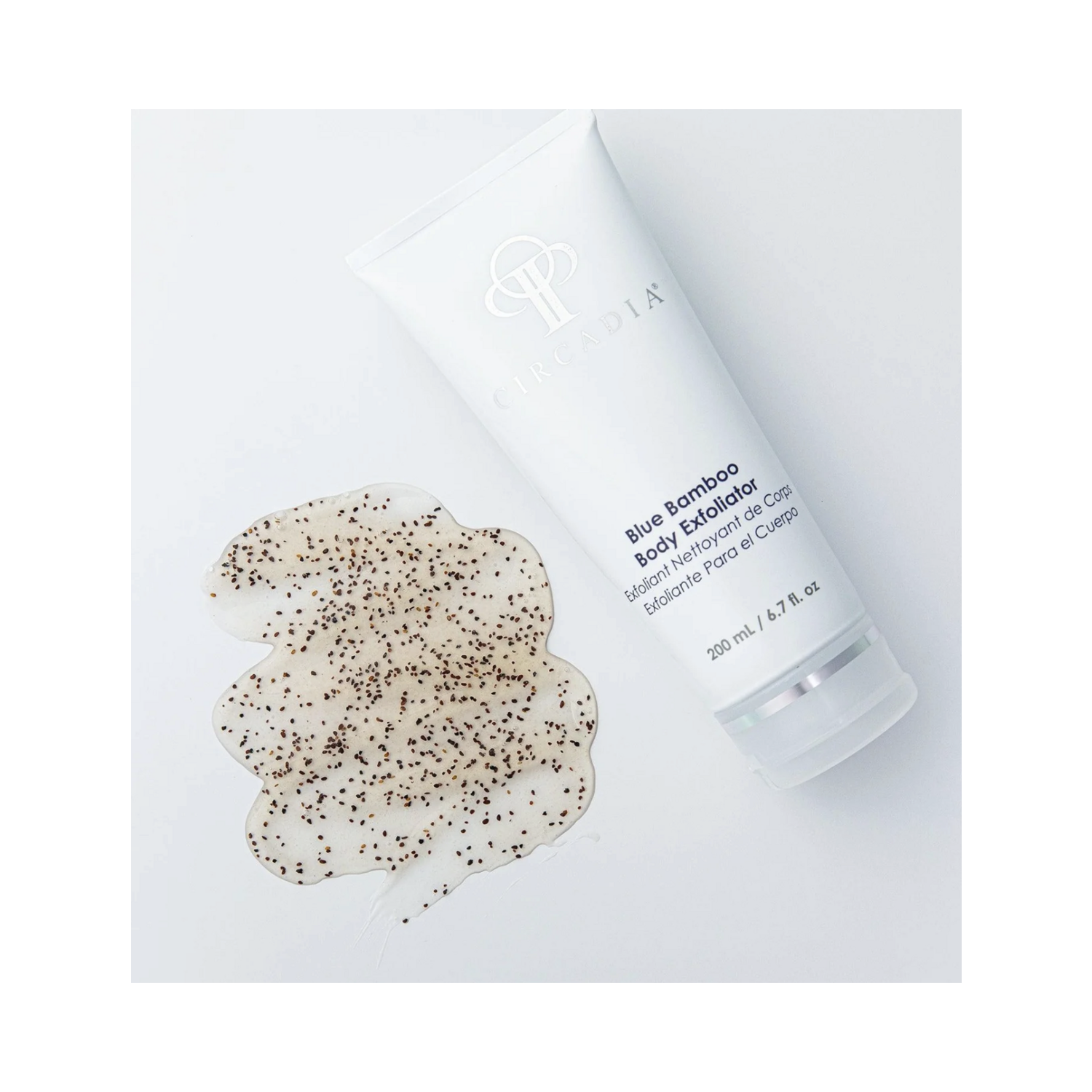 Circadia Blue Bamboo Body Exfoliator with visible blueberry seeds shown next to product texture, highlighting natural exfoliating ingredients.