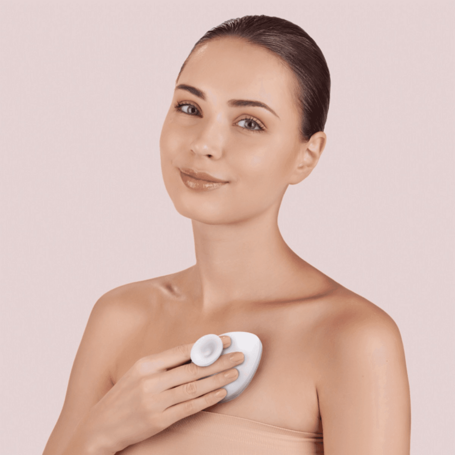 Model using white Geske Body Brush 4 in 1 on chest area, demonstrating its gentle exfoliation and skin-smoothing benefits for body care.