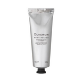 Hand squeezing Olverum Body Polish from silver tube. Lightweight exfoliating cream ideal for skin maintenance and hydration.