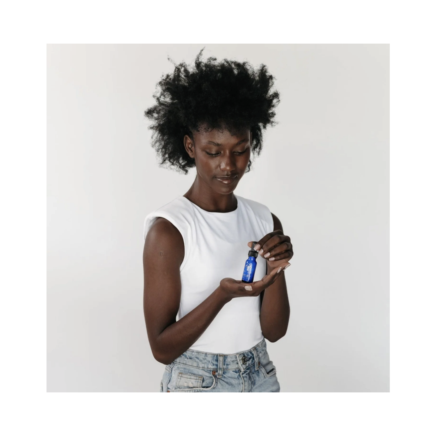 Woman holding Circadia Bright White Serum, a face treatment with antioxidants for radiant skin, available at eSkinStore.