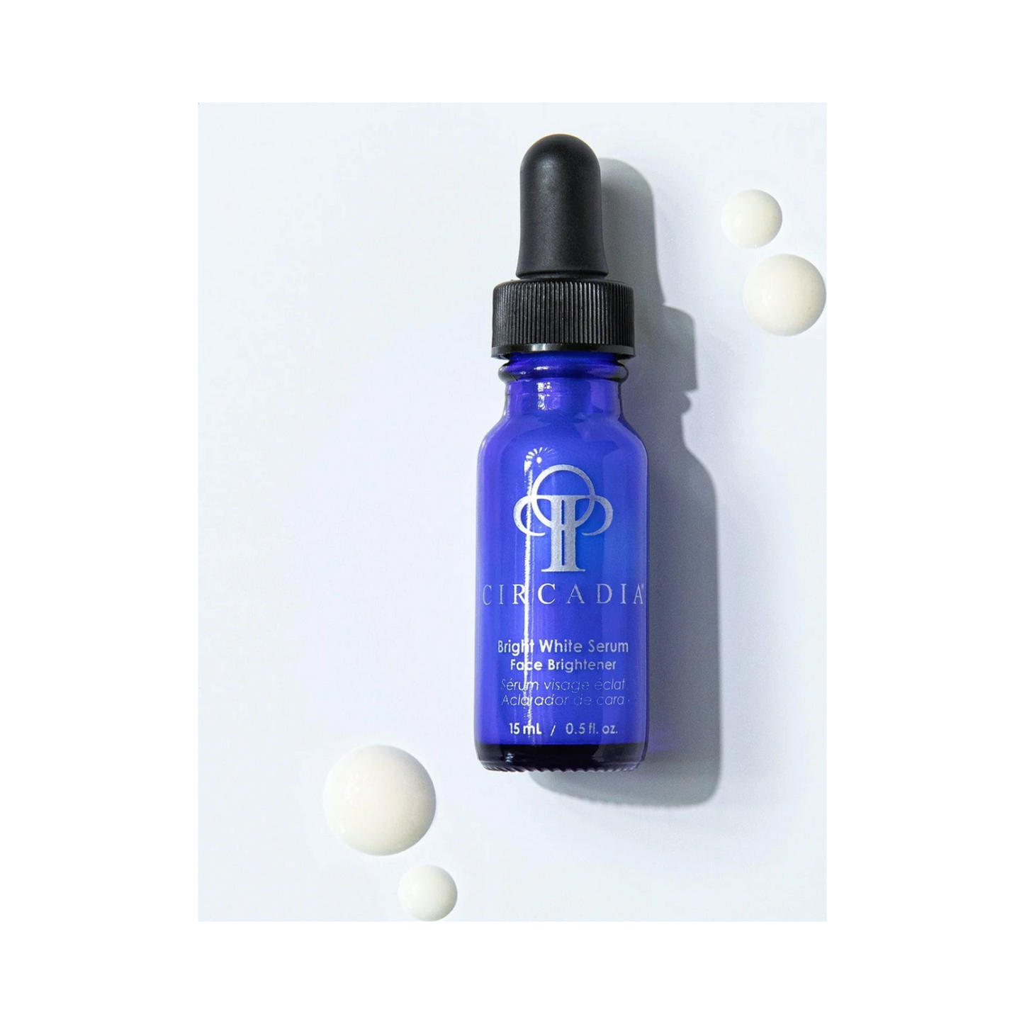 Circadia Bright White Serum bottle with serum drops on white background, designed to brighten skin and fade dark spots.