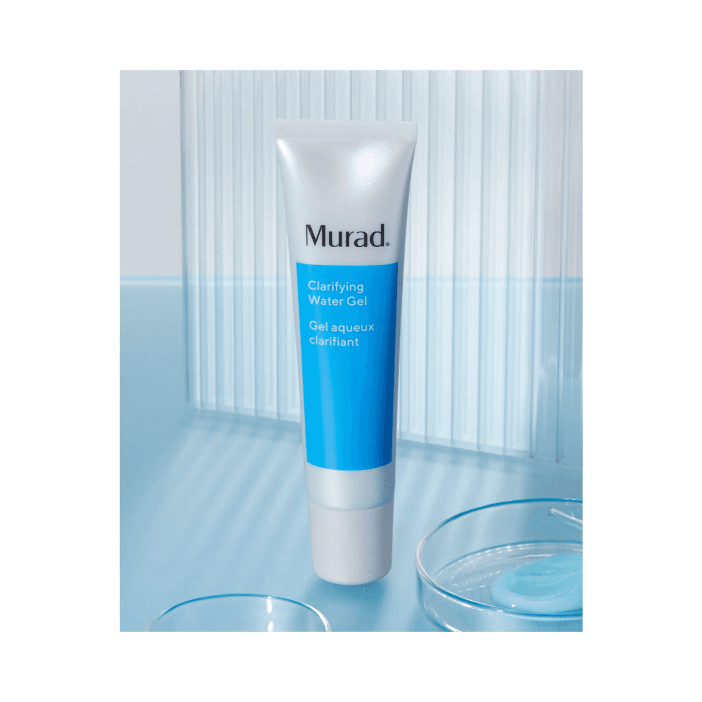 Murad Clarifying Water Gel displayed on a blue surface with clear gel texture, showcasing its lightweight, non-comedogenic formula.