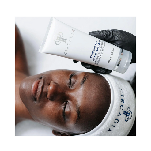 Esthetician applying Circadia Cleansing Gel with Mandelic Acid during facial treatment, ideal for brightening and exfoliating skin.