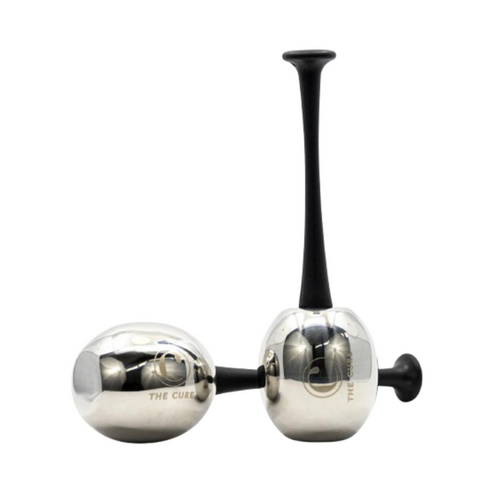 The Cure Skincare Cold Rollers with sleek stainless steel heads and black ergonomic handles for puffiness reducing skincare routines.