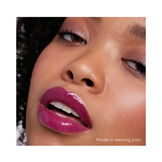 Model applying Jane Iredale Colorluxe Lip Glaze in Cherry Noir, highlighting a deep, glossy burgundy lip for a dramatic look.