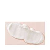 Creamy texture of Living Proof Curl Elongator hair treatment, formulated to hydrate and elongate tight curls with jojoba and lactic acid.