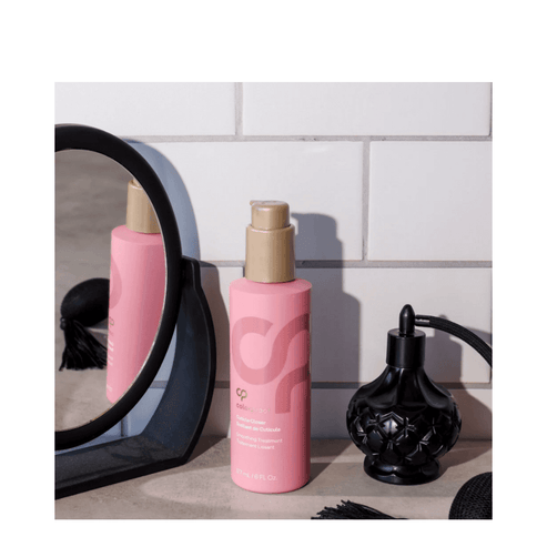 ColorProof Cuticle Closer Hair Treatment placed on bathroom counter with mirror and perfume bottle, ideal for frizz control and glossy hair.