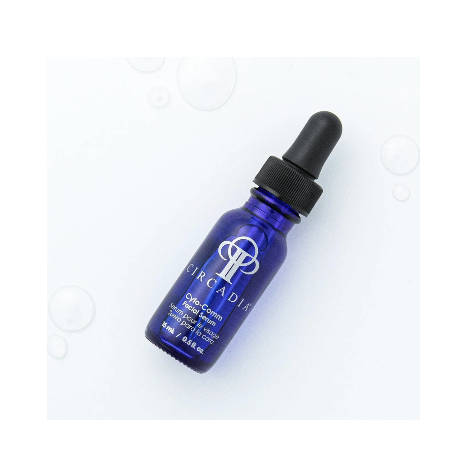 Circadia Cyto-comm Serum 0.5 fl oz dropper bottle on a white background with water droplets, ideal for mature skin care.