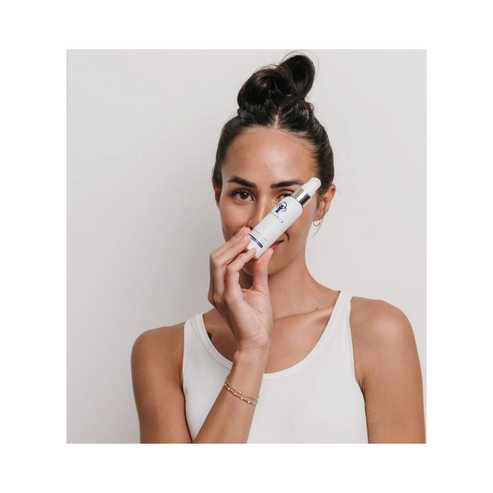 Woman holding Circadia Daytime Control Lotion - Skincare Essentials, a hydrating face serum for daily use on oily skin types.