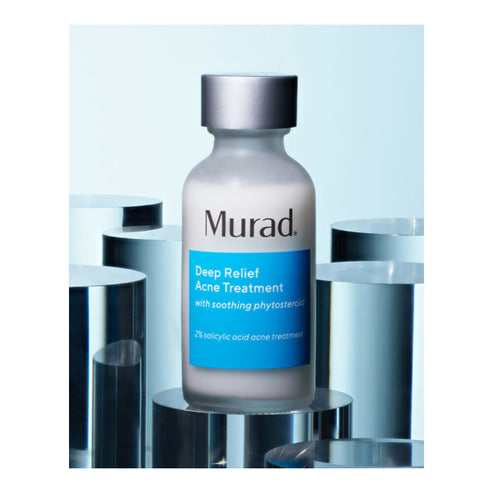 Murad Deep Relief Acne Treatment serum bottle placed on mirrored surfaces, emphasizing its clinical skincare appeal.