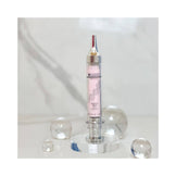 Janssen Epigenetic Serum displayed on a clear stand with decorative spheres. Premium face serum for resilient, youthful skin.