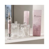 Janssen Epigenetic Serum placed on vanity beside cotton swabs. Skincare treatment targeting fine lines and mature skin concerns.