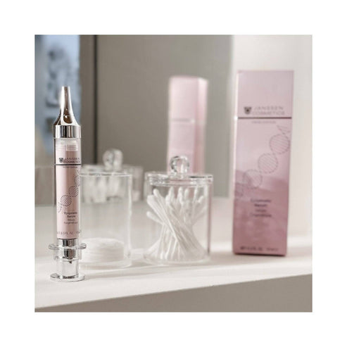 Janssen Epigenetic Serum placed on vanity beside cotton swabs. Skincare treatment targeting fine lines and mature skin concerns.