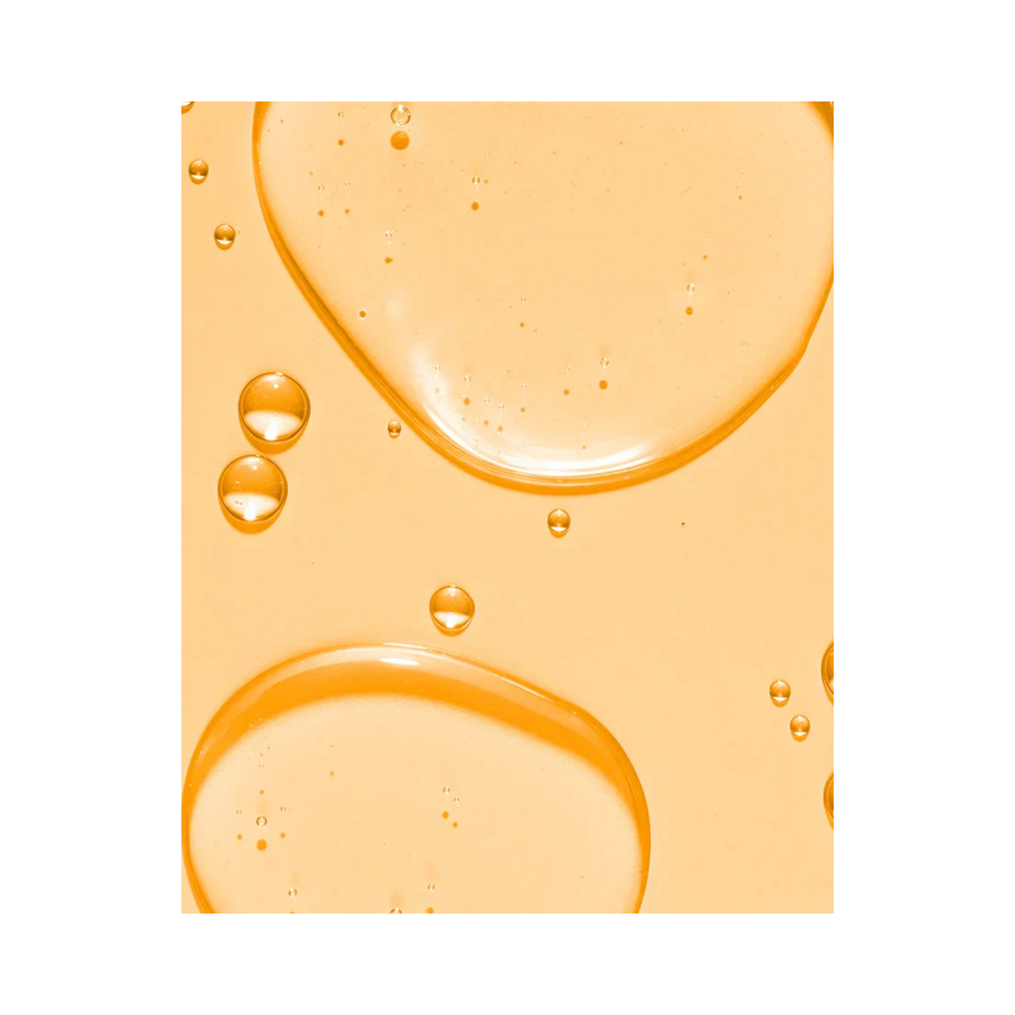 Close-up texture of Murad Essential-C Cleanser gel with orange-tinted bubbles, highlighting its hydrating and revitalizing formula.