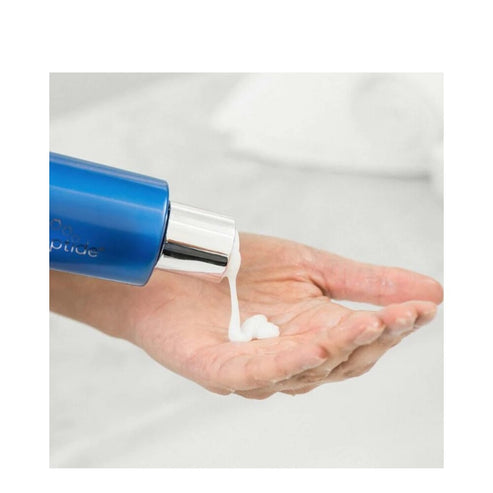 Application of HydroPeptide Cleanser from pump bottle onto hand, showcasing ease of use and creamy exfoliating texture.