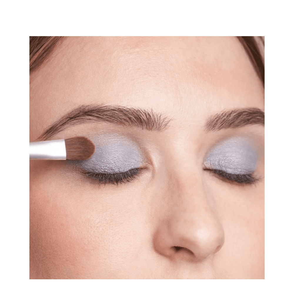 Close-up of T LeClerc Eye Shadow 2.5g in blue being applied with a brush, showcasing its buildable coverage.