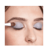 Close-up of T LeClerc Eye Shadow 2.5g in blue being applied with a brush, showcasing its buildable coverage.