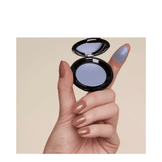 T LeClerc Eye Shadow 2.5g in blue shown on fingertip for color payoff, ideal for customizable eye makeup looks.