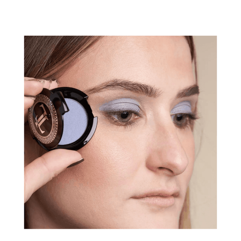 Model applying T LeClerc Eye Shadow 2.5g in blue, demonstrating smooth blendability and vibrant finish on eyelids.