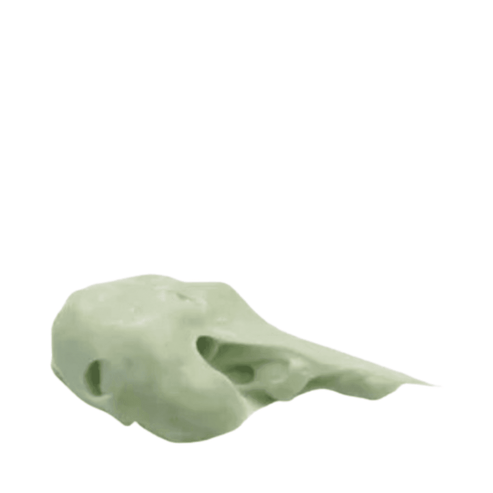 Green cream texture of The Cure Skincare Face + Eye Cream, showcasing its rich, hydrating consistency for all skin types.