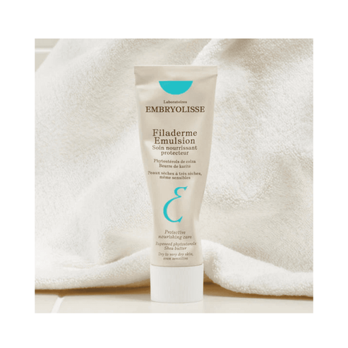 Embryolisse Filaderme Emulsion face cream displayed on a soft towel, emphasizing its soothing and moisturizing benefits for dry skin.