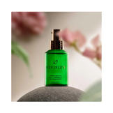 High on Love Firming Body Oil placed on a stone with soft floral accents, promoting luxury skincare from eSkinStore’s bath & body range.