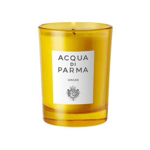 Acqua Di Parma Candle in yellow glass jar with label 'Grazie', featuring rose and ylang-ylang scent. Elegant gift candle for home fragrance lovers.
