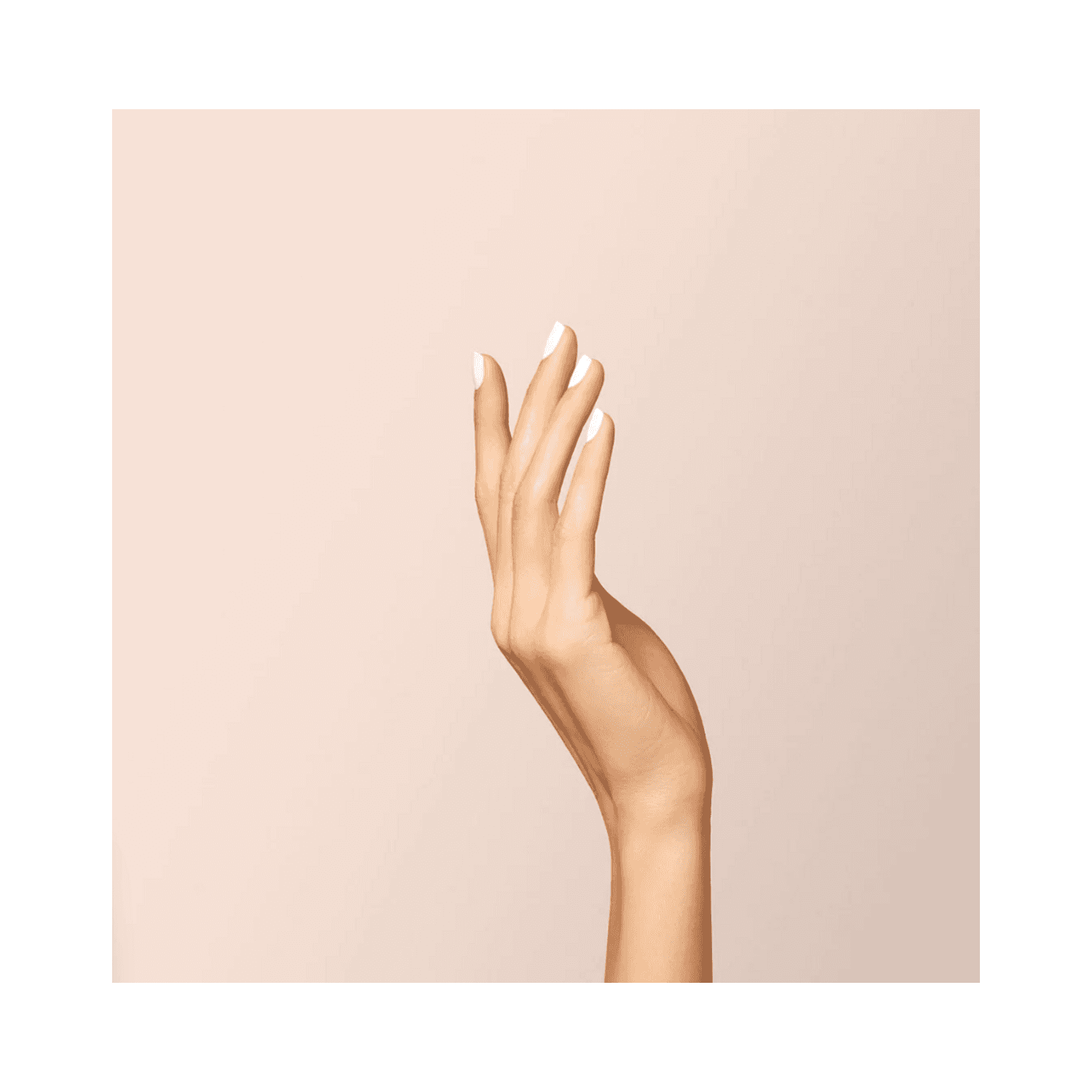 Elegant hand pose showing glossy white nails coated with Manucurist Green Flash Snow nail polish.