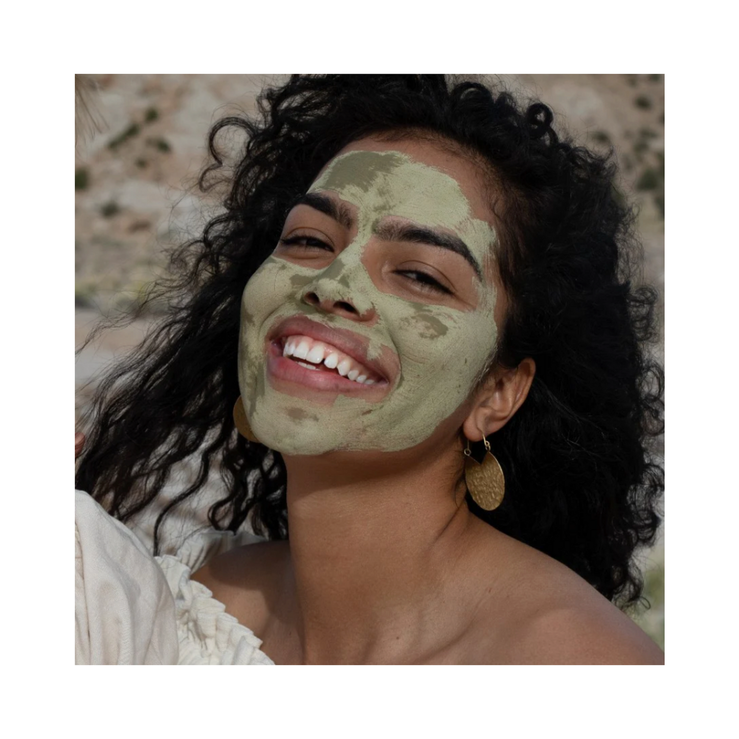 Smiling woman wearing Evanhealy Green Tea Clay Mask, showcasing its use for refreshing and balancing mature or blemish-prone skin.
