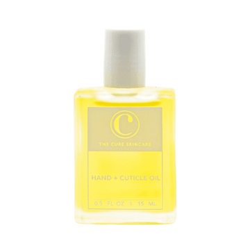 The Cure Skincare Oil - Hand Cuticle Oil in 15ml glass bottle with rollerball applicator for hydrating hands and strengthening nails.