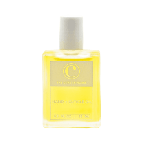 Hydrating The Cure Skincare Hand + Cuticle Oil for nail care, featuring nourishing formula in compact 0.5 fl oz bottle for mess-free application.