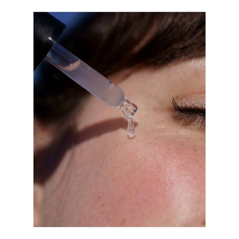 Close-up of Algologie Hydra-Replenish Booster serum dropper applying product to skin, showcasing its hydrating and soothing benefits.