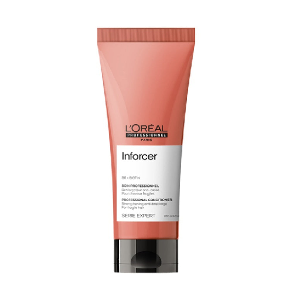 L'oreal Professional Paris Inforcer Conditioner in coral packaging. Ideal for damaged hair, enriched with Biotin to reduce breakage and boost strength.