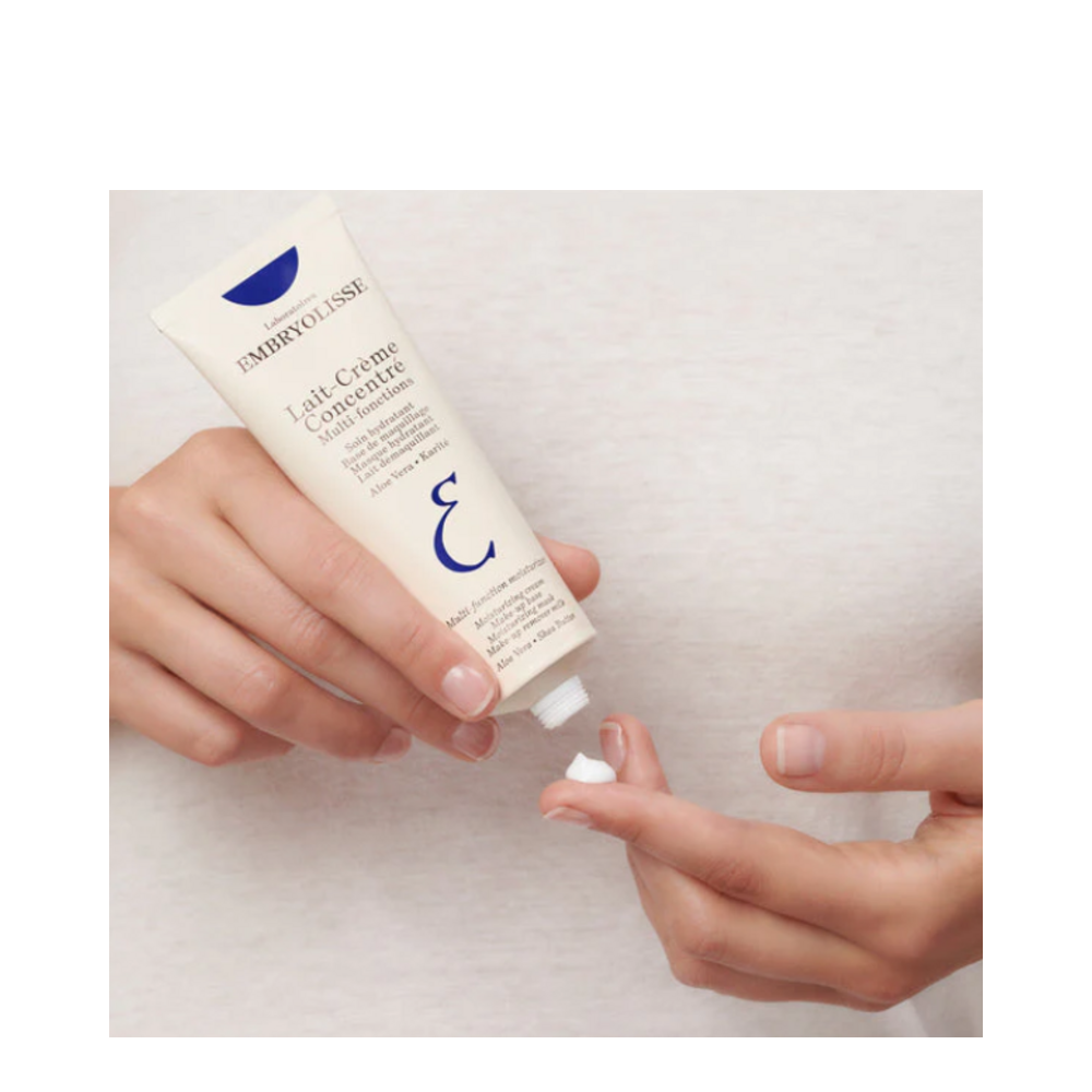 Person applying Embryolisse Lait-Creme Concentre moisturizer, highlighting its creamy texture and hydrating benefits for facial skincare.