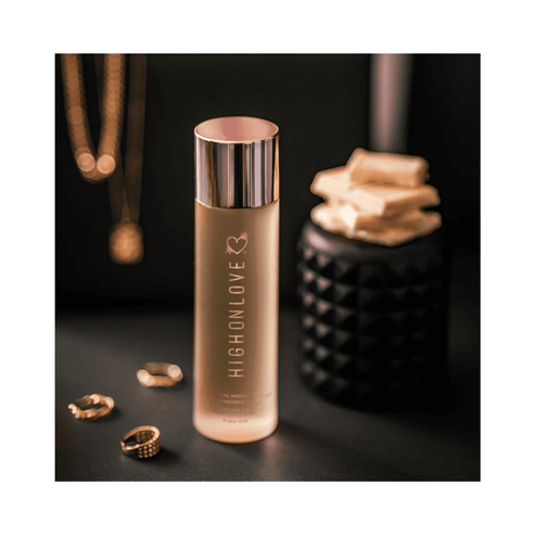 High on Love Massage Oil Topical Sunset Body Oil showcased with gold jewelry and black decor, perfect for premium personal care collections.